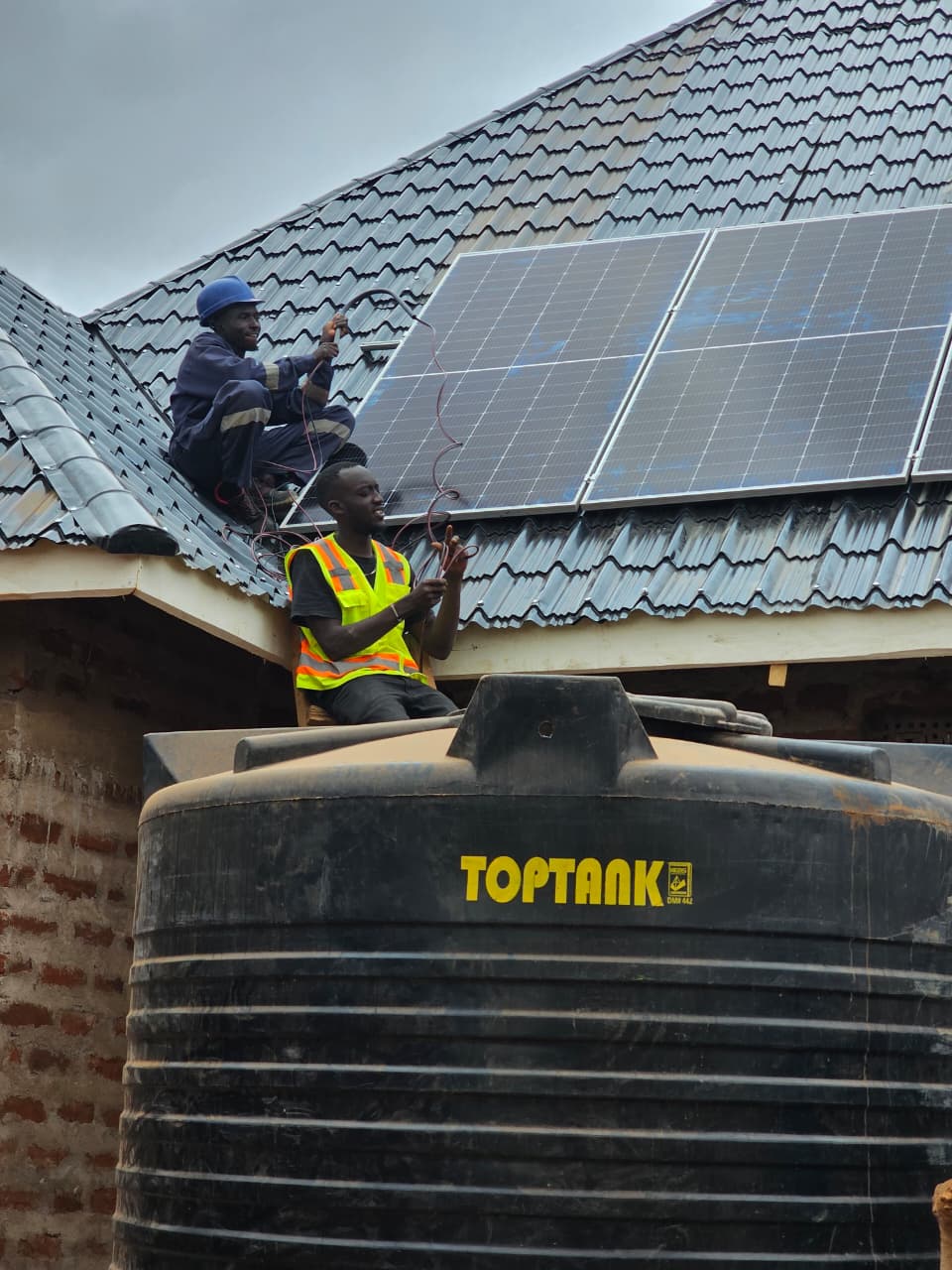 Sundara Africa technical team installing solar equipment indoors